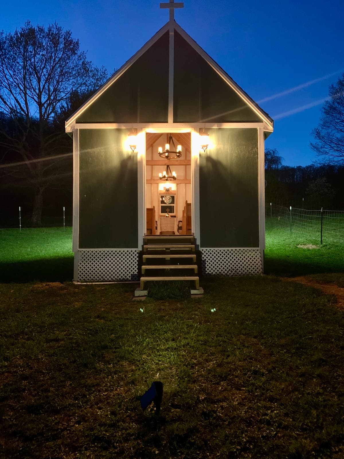 Chapel exterior at night, lit from within