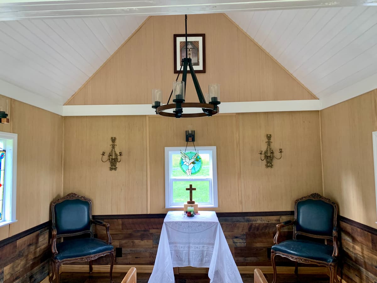 Chapel altar area with cross and chandelier