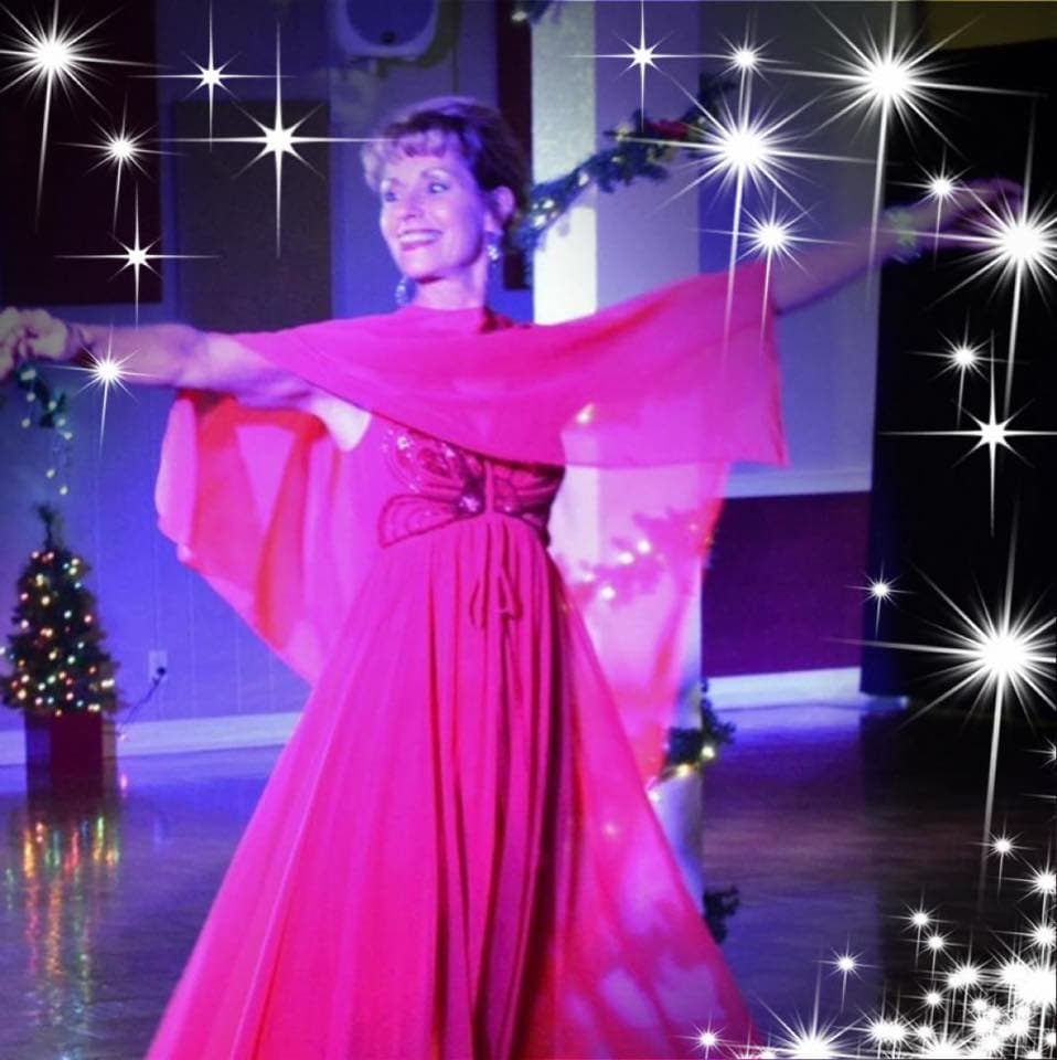 Wendy Jones Crowe performing a ballroom dance in a red gown